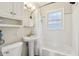 Bathroom features a pedestal sink, tiled walls and tub with shower at 473 N 17Th St, Noblesville, IN 46060