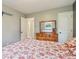 Bedroom with hardwood floors, dresser and view into bathroom at 473 N 17Th St, Noblesville, IN 46060