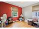 Bedroom with hardwood floors, window, and red accent wall at 473 N 17Th St, Noblesville, IN 46060