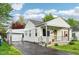 Attractive home with a detached garage, covered porch, and well-kept lawn, blending charm with functionality at 473 N 17Th St, Noblesville, IN 46060