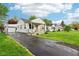 Inviting home with a well-manicured lawn, long driveway, and quaint covered front porch, offering curb appeal at 473 N 17Th St, Noblesville, IN 46060