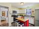 Well lit kitchen with stainless steel appliances, island with seating, and cabinets at 473 N 17Th St, Noblesville, IN 46060