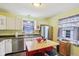 Bright kitchen with stainless steel appliances, white cabinets, island with stools and window at 473 N 17Th St, Noblesville, IN 46060