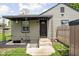 Home's back entrance features a covered porch, access to the basement, and leads to a fenced backyard at 4902 Kingsley Dr, Indianapolis, IN 46205
