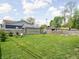 Large backyard featuring a shed, seating area, manicured lawn, and a wooden privacy fence at 4902 Kingsley Dr, Indianapolis, IN 46205