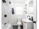 Bathroom features marbled shower, sleek black fixtures, and floating shelves at 4902 Kingsley Dr, Indianapolis, IN 46205