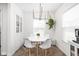 Bright dining area with modern lighting, seating for four, and stylish decor at 4902 Kingsley Dr, Indianapolis, IN 46205