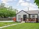 Inviting single-story home with well-manicured lawn, tidy landscaping, and a welcoming front porch at 4902 Kingsley Dr, Indianapolis, IN 46205