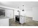 Kitchen island features stone countertops, sleek appliances and modern hardware at 4902 Kingsley Dr, Indianapolis, IN 46205