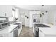 Bright kitchen with stainless steel appliances, white cabinets, and a spacious island with seating at 4902 Kingsley Dr, Indianapolis, IN 46205