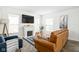 Bright living room with fireplace, large TV, and comfortable seating with attractive decor at 4902 Kingsley Dr, Indianapolis, IN 46205