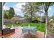 Lush backyard with a wooden deck featuring patio furniture and a BBQ grill at 4917 N Park Ave, Indianapolis, IN 46205