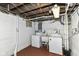 Basement laundry area with washer, dryer, and utility sink for convenience at 4917 N Park Ave, Indianapolis, IN 46205