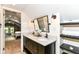 Bathroom features a double sink vanity, modern fixtures, and a view to the main bedroom at 4917 N Park Ave, Indianapolis, IN 46205