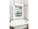 Classic bathroom with a clawfoot tub and vintage-style shower fixtures below a window at 4917 N Park Ave, Indianapolis, IN 46205
