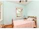 Inviting bedroom featuring hardwood floors, soft lighting, and a classic wooden bed frame at 4917 N Park Ave, Indianapolis, IN 46205