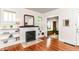 Sunlit living room featuring a fireplace and gleaming hardwood floors at 4917 N Park Ave, Indianapolis, IN 46205
