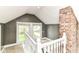Spacious loft area with natural light, railing, and a view to the neighborhood below at 4917 N Park Ave, Indianapolis, IN 46205