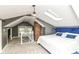 Cozy main bedroom with a skylight, brick feature, and plush blue headboard at 4917 N Park Ave, Indianapolis, IN 46205