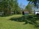 View of large backyard with shed and mature trees, a great space for relaxation and recreation at 4927 Mathews Ave, Indianapolis, IN 46227