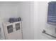 Bright bathroom showing linen storage cabinet, modern towel racks, and painted white walls at 4927 Mathews Ave, Indianapolis, IN 46227
