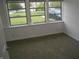 Bedroom with three-pane window looking out onto a well-kept lawn at 4927 Mathews Ave, Indianapolis, IN 46227
