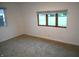 Bedroom with natural light from large window, neutral paint, and carpet at 4927 Mathews Ave, Indianapolis, IN 46227