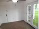 Bedroom showing tile flooring, glass-paneled doors to the exterior, and a ceiling fan at 4927 Mathews Ave, Indianapolis, IN 46227