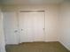 This bedroom features a closet with double doors and neutral carpeting at 4927 Mathews Ave, Indianapolis, IN 46227