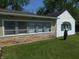 Exterior view showcasing the stone accent wall and the well-maintained yard at 4927 Mathews Ave, Indianapolis, IN 46227