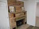 Charming brick fireplace with mantel and decorative floral artwork in living area at 4927 Mathews Ave, Indianapolis, IN 46227