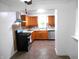 Efficient kitchen with tile flooring, stainless appliances, and wood cabinets at 4927 Mathews Ave, Indianapolis, IN 46227
