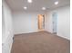 Spacious room featuring carpet and white walls, with doorways leading to other areas at 4927 Mathews Ave, Indianapolis, IN 46227