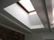 A large skylight brightens this room; notice the beams and decorative brick at 4927 Mathews Ave, Indianapolis, IN 46227