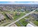 Panoramic aerial view of a community highlighting diverse homes and a scenic pond area, all beneath a bright, cloud-dappled sky at 4940 Sundance Trl, Indianapolis, IN 46239