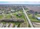 Extensive aerial shot of a residential area with a mix of homes and natural features including a picturesque pond and open fields at 4940 Sundance Trl, Indianapolis, IN 46239