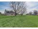 Lush green backyard with mature trees, providing ample space and scenic views of the home at 4940 Sundance Trl, Indianapolis, IN 46239