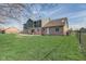 Spacious backyard featuring a brick and siding home with a patio and well-maintained lawn at 4940 Sundance Trl, Indianapolis, IN 46239