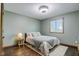 Neutral bedroom with hardwood floors, a large window, and a comfortable queen-sized bed at 4940 Sundance Trl, Indianapolis, IN 46239