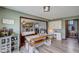 Cozy dining area with rustic wood table and benches, adjacent to open living space and study nook at 4940 Sundance Trl, Indianapolis, IN 46239
