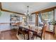 Formal dining room featuring a traditional wood table and view of staircase to upper level at 4940 Sundance Trl, Indianapolis, IN 46239