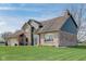 A beautiful home with a brick and siding exterior and a well-maintained lawn on a sunny day at 4940 Sundance Trl, Indianapolis, IN 46239