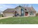 A well-maintained home featuring a two-car garage, brick accents, and fresh green lawn at 4940 Sundance Trl, Indianapolis, IN 46239