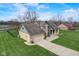 Well-maintained home with brick and siding, boasting a spacious lawn and a convenient two-car garage at 4940 Sundance Trl, Indianapolis, IN 46239