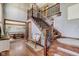 Grand foyer featuring hardwood floors, a staircase with iron railings, and an adjacent dining area at 4940 Sundance Trl, Indianapolis, IN 46239