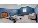 Home gym with workout equipment and blue accent wall at 4940 Sundance Trl, Indianapolis, IN 46239