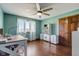 Home office featuring a fan, desk, storage cabinets and hardwood floors at 4940 Sundance Trl, Indianapolis, IN 46239