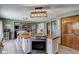 Charming kitchen with island cooktop, stainless appliances, and view into living area with fireplace at 4940 Sundance Trl, Indianapolis, IN 46239