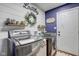 Well-organized laundry room featuring a modern washer and dryer and farmhouse decor at 4940 Sundance Trl, Indianapolis, IN 46239