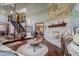 Spacious living room with a brick fireplace, hardwood floors, and a staircase with iron railings at 4940 Sundance Trl, Indianapolis, IN 46239